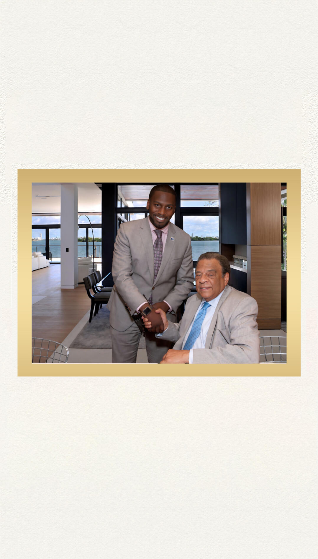 Micah Berkley shaking hands with Andrew Young Jr. in a Miami office overlooking the water.