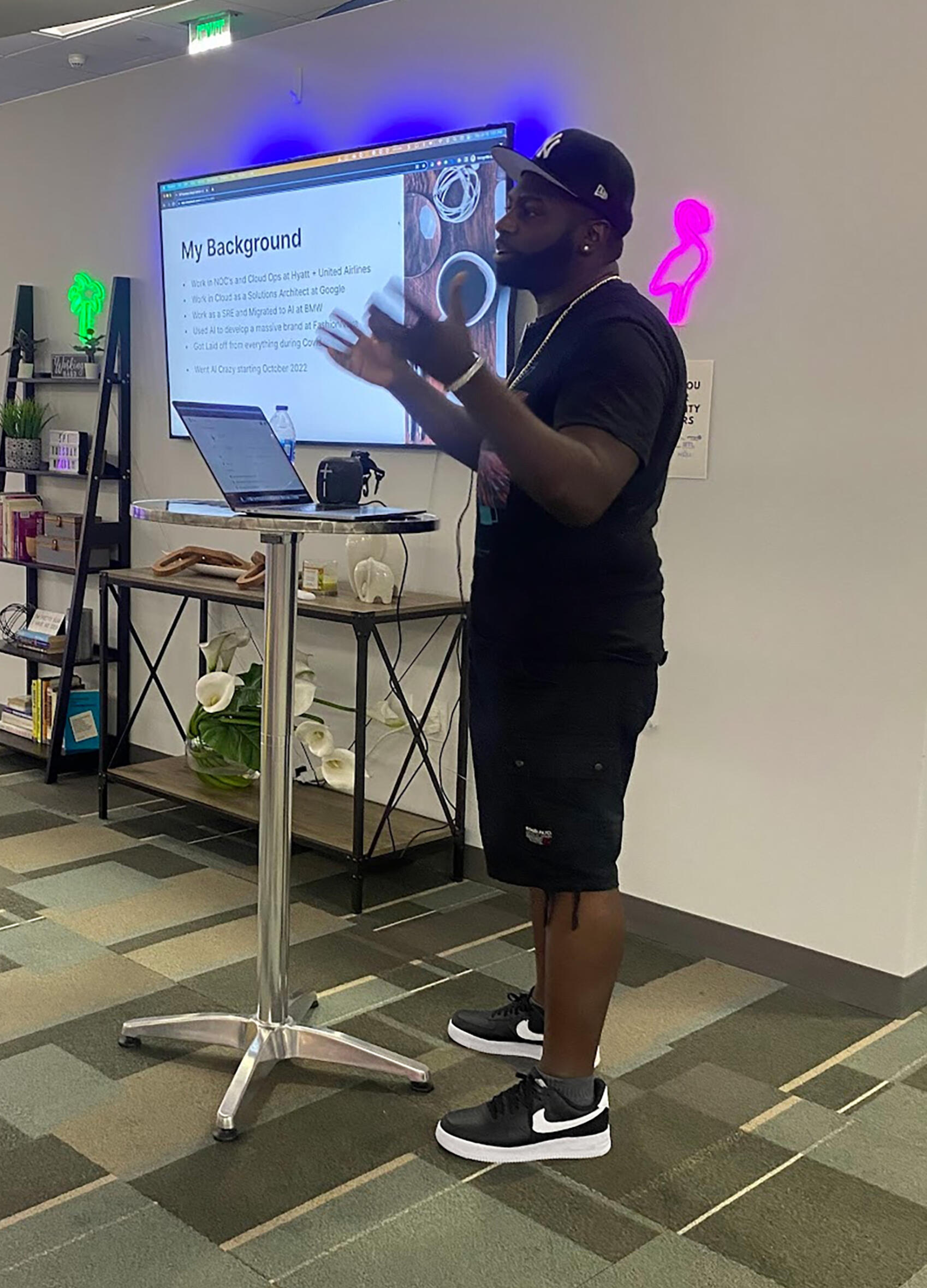 Micah Berkley leading a 'GPT Tuesdays' event in Miami with a presentation on his background, featuring Grant Cardone.